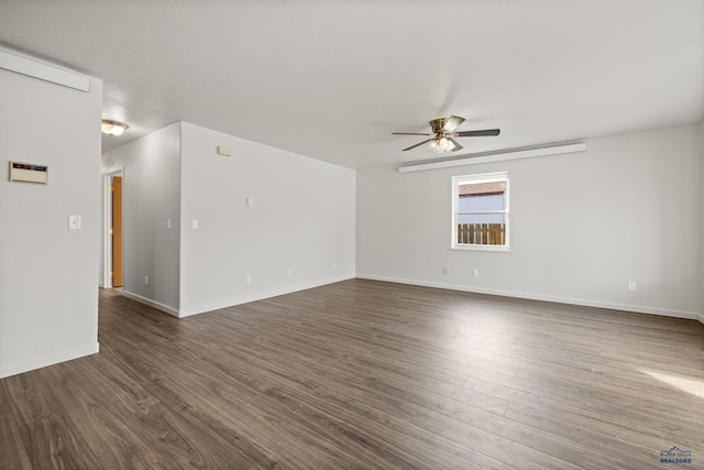 empty room with ceiling fan and dark wood-type flooring