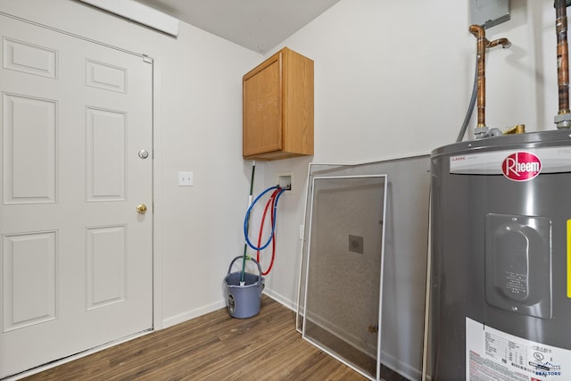 laundry room featuring hookup for a washing machine, cabinets, dark hardwood / wood-style floors, and water heater