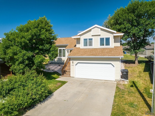 view of front of house featuring a garage and a front lawn