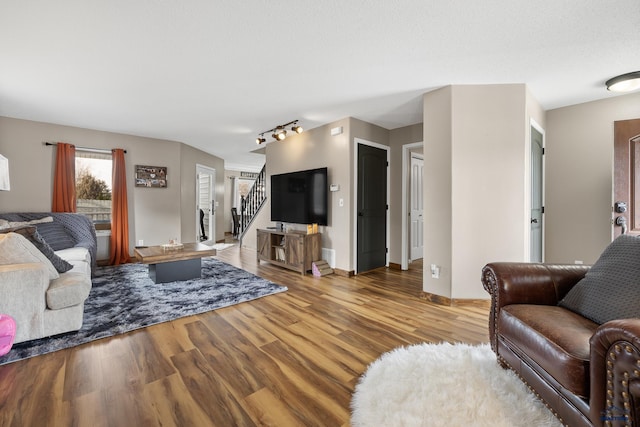 living room featuring light wood-type flooring and rail lighting