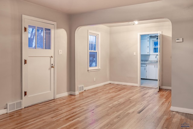 foyer featuring sink and light hardwood / wood-style flooring