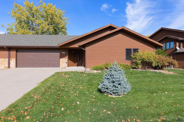 view of front of property with a garage and a front yard