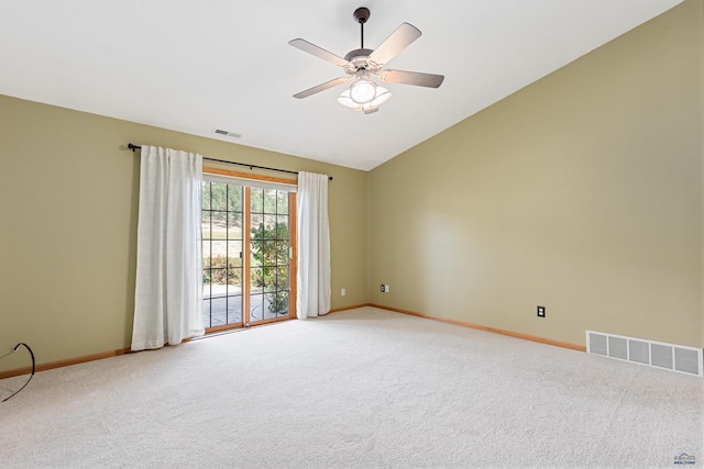 spare room featuring lofted ceiling, ceiling fan, and carpet flooring