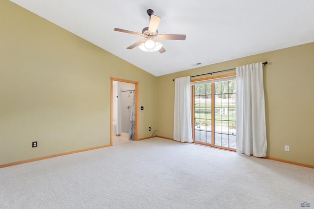 carpeted spare room featuring vaulted ceiling and ceiling fan