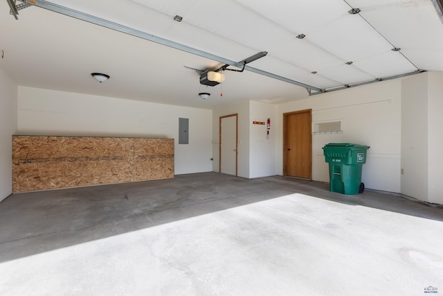 garage with a garage door opener and electric panel