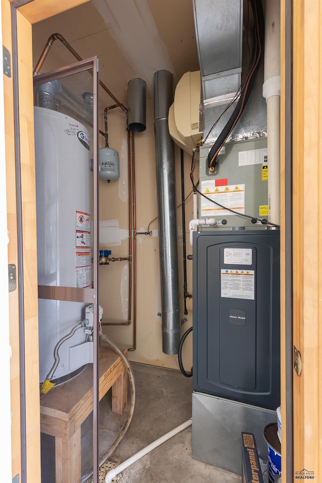 utility room featuring water heater