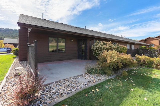 ranch-style house with a front yard and a patio area