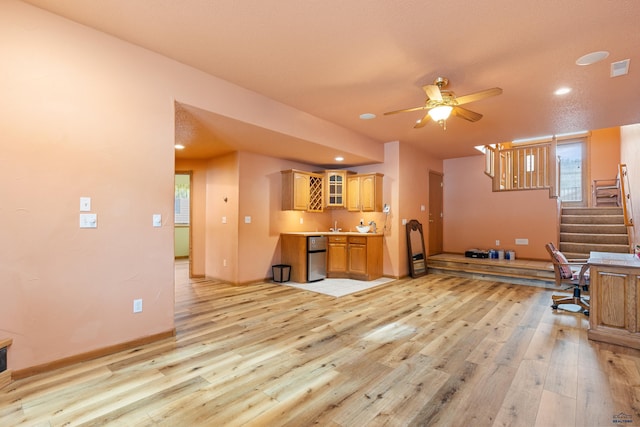 interior space with stainless steel dishwasher, ceiling fan, and light wood-type flooring