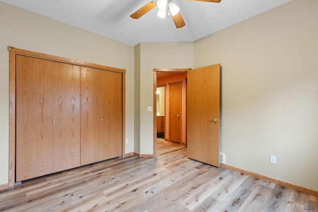 unfurnished bedroom featuring ceiling fan, a closet, and light hardwood / wood-style flooring