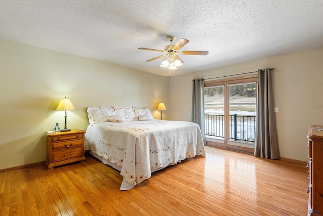 bedroom with ceiling fan, access to exterior, a textured ceiling, and light wood-type flooring