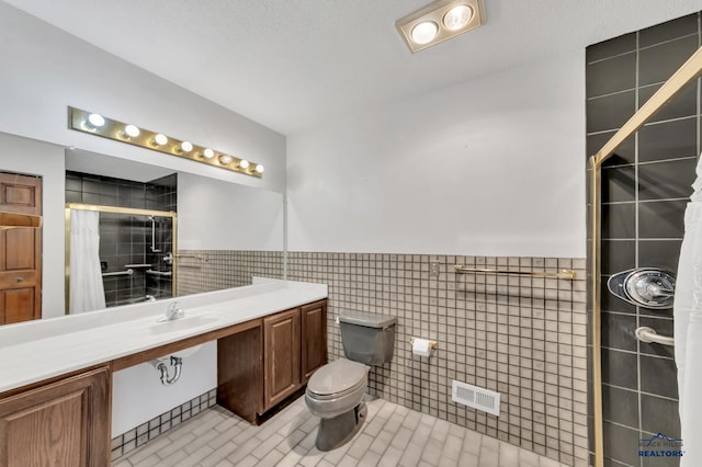 bathroom with tile walls, a shower with curtain, tile patterned floors, and toilet