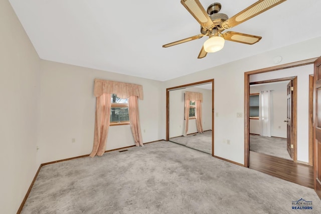 unfurnished bedroom with ceiling fan and light colored carpet