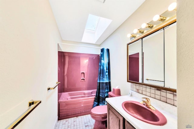 full bathroom featuring shower / bath combination with curtain, vanity, toilet, and a skylight