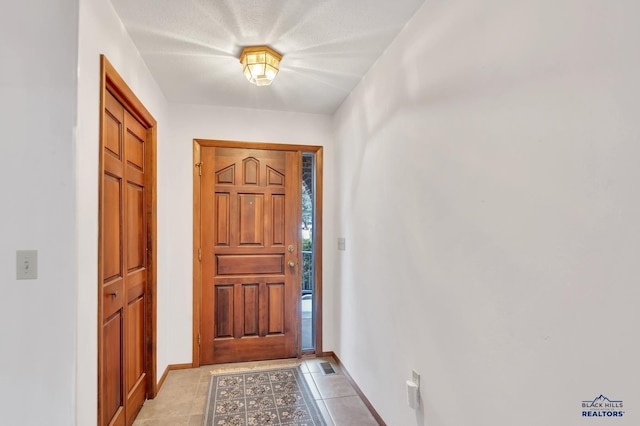 doorway featuring light tile patterned floors