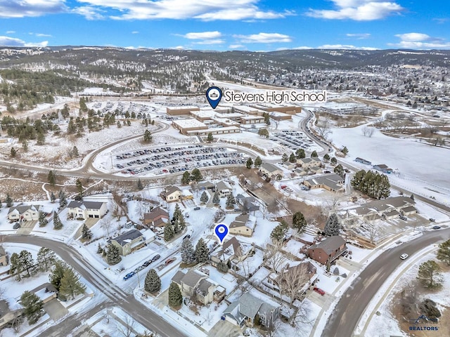 snowy aerial view with a mountain view