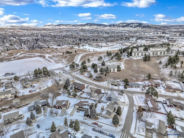 snowy aerial view featuring a mountain view