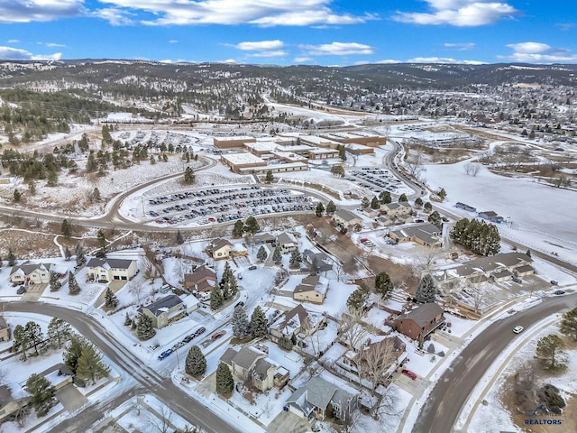 snowy aerial view with a mountain view