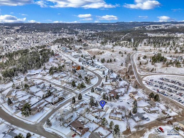 snowy aerial view featuring a mountain view