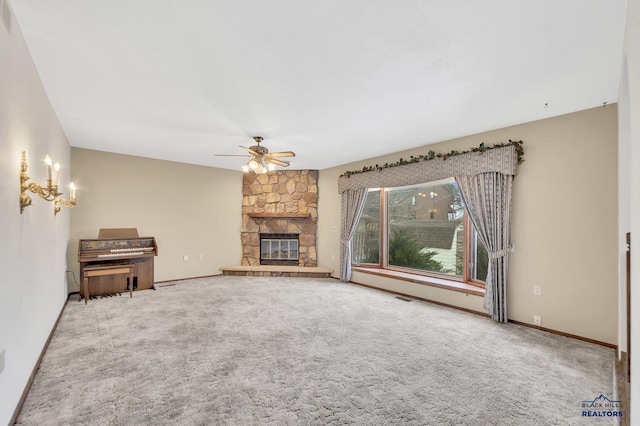 unfurnished living room with a fireplace, ceiling fan, and carpet