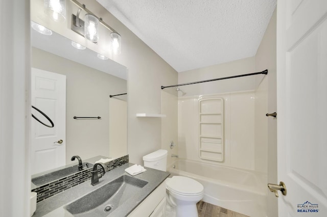 full bathroom featuring toilet, a textured ceiling, shower / washtub combination, vanity, and hardwood / wood-style floors