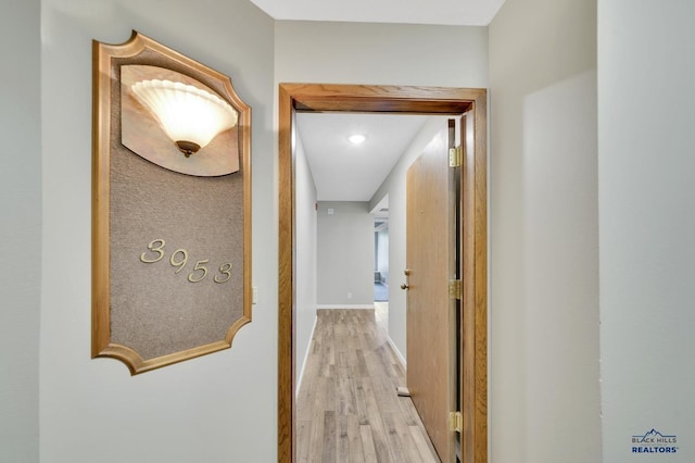 hallway with light hardwood / wood-style flooring