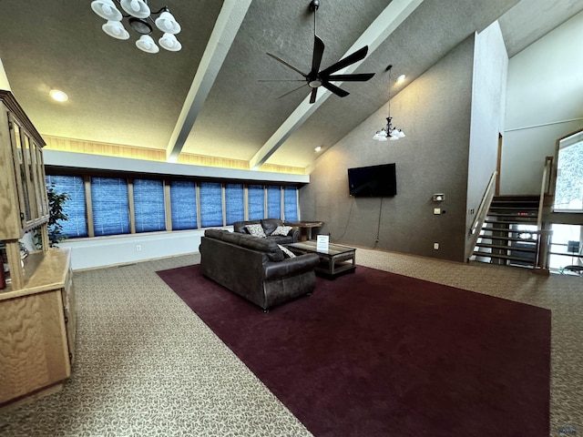 carpeted living room with beamed ceiling, ceiling fan, and high vaulted ceiling