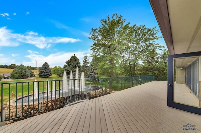 wooden deck with a lawn