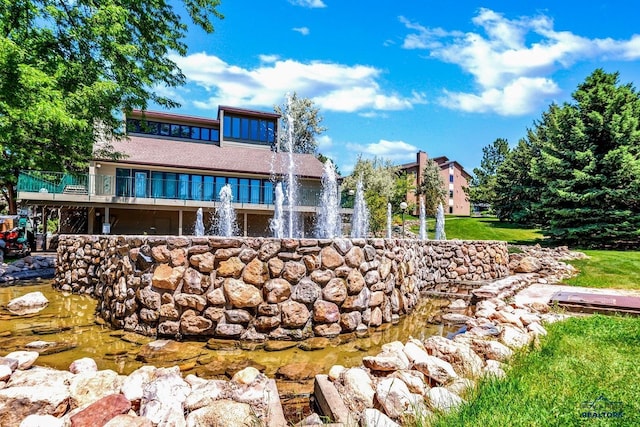 exterior space featuring a garden pond