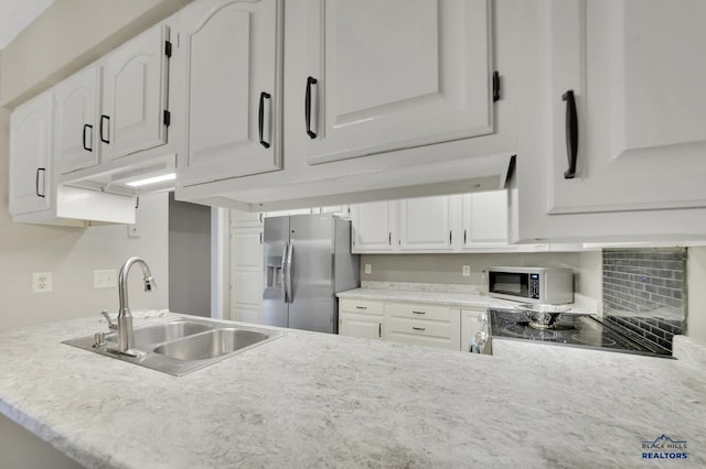 kitchen featuring sink, white cabinets, and appliances with stainless steel finishes