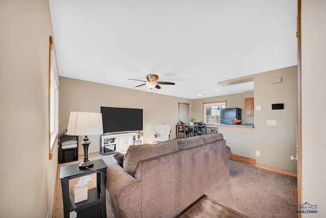 living room featuring ceiling fan and carpet flooring