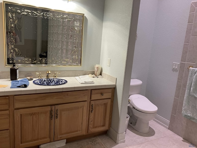 14390 Edgewood Pl, Piedmont, SD 57769 - bathroom featuring toilet, vanity, tile patterned flooring, and a textured wall