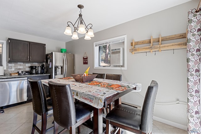 dining space featuring light tile patterned flooring and a chandelier