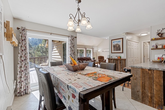 dining space featuring light tile patterned flooring, vaulted ceiling, and a notable chandelier