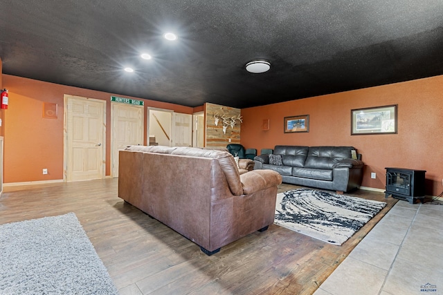 living room featuring hardwood / wood-style floors and a wood stove