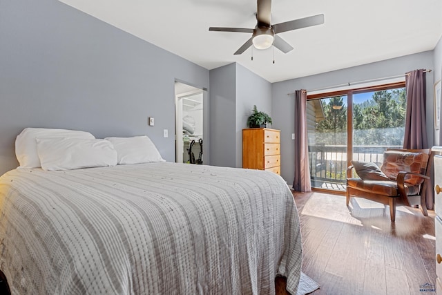 bedroom featuring access to exterior, wood-type flooring, and ceiling fan