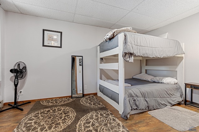 bedroom featuring a paneled ceiling and wood-type flooring