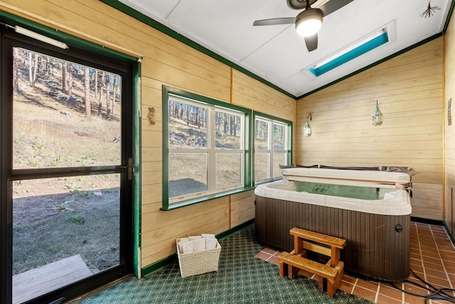 sunroom / solarium with a hot tub, lofted ceiling, and ceiling fan