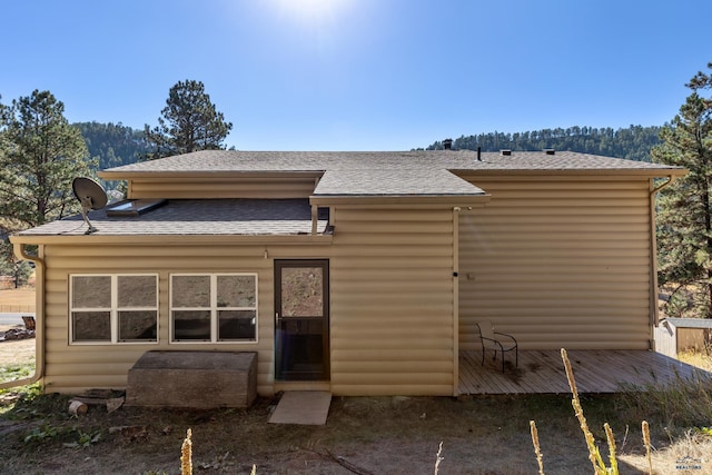 back of house with a wooden deck