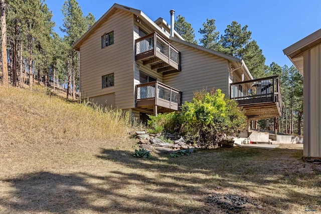 rear view of property with a balcony