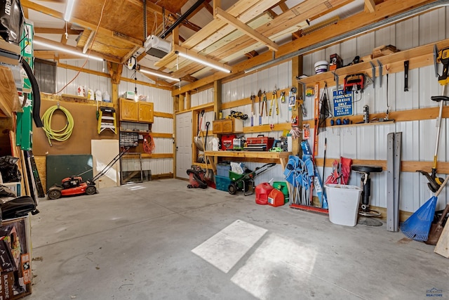 garage with a garage door opener and a workshop area