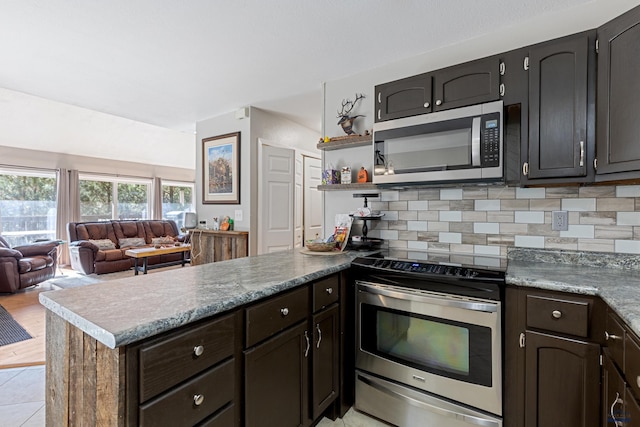 kitchen with stainless steel appliances, tasteful backsplash, and light tile patterned flooring