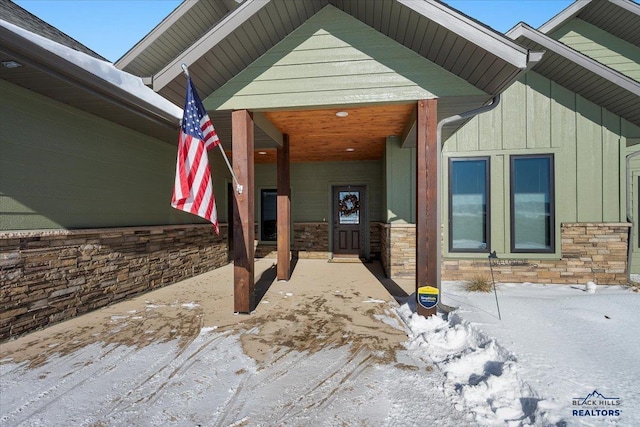 view of snow covered property entrance