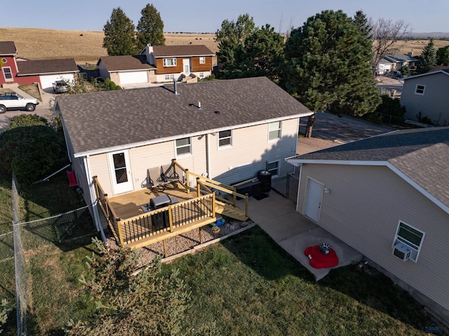 rear view of house with a deck and a lawn