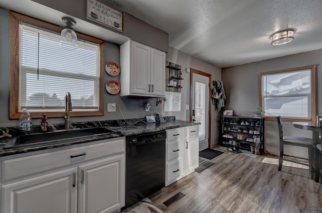 kitchen featuring white cabinetry, dishwasher, sink, and a textured ceiling