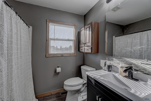 bathroom with vanity, curtained shower, and toilet