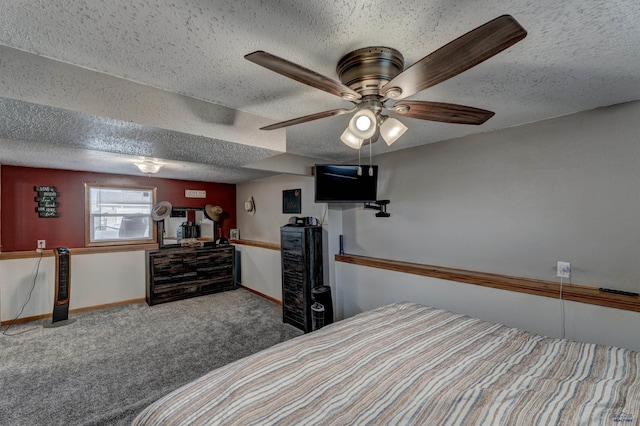 bedroom with a textured ceiling, ceiling fan, and carpet flooring