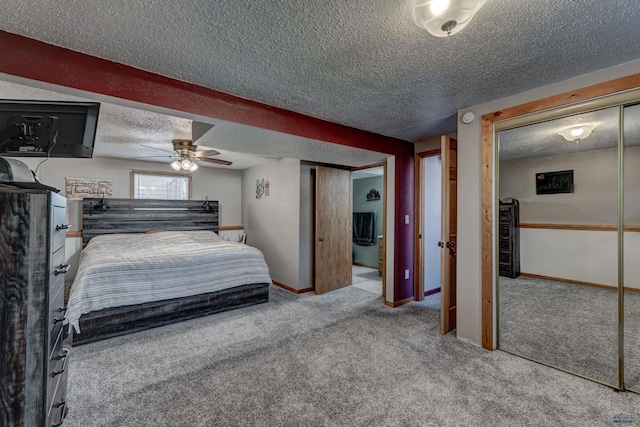 carpeted bedroom with a textured ceiling and ceiling fan