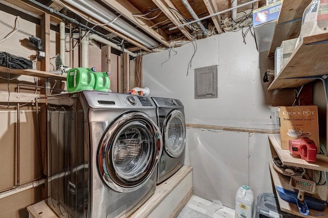 clothes washing area with washer and clothes dryer