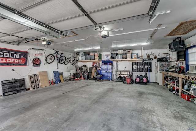 garage featuring a garage door opener and a workshop area