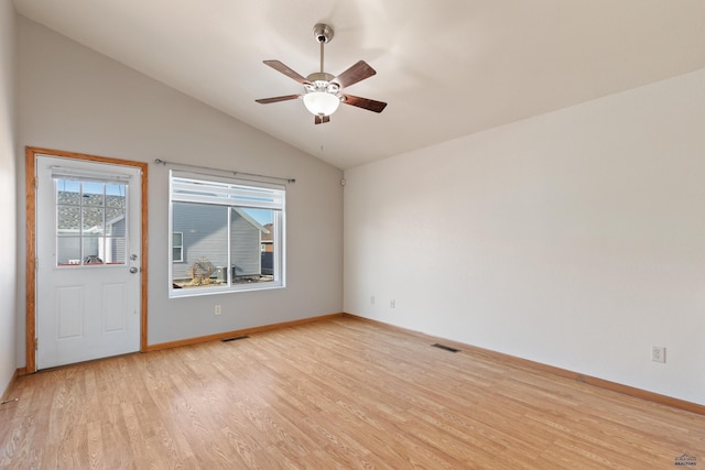 spare room featuring vaulted ceiling, ceiling fan, and light hardwood / wood-style flooring